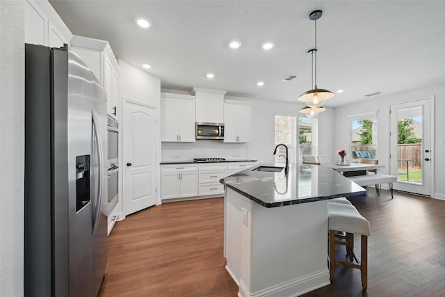 3501 Alamosa River Dr, Prosper, TX 75078 - kitchen with stainless steel appliances, a sink, dark wood-style floors, recessed lighting, and white cabinets
