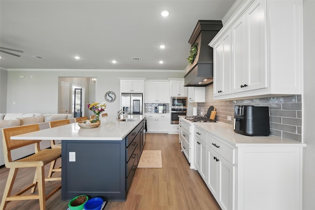 132 Parkview Ln, Boyd, TX 76023 - kitchen with appliances with stainless steel finishes, a sink, crown molding, a breakfast bar area, and light wood-style floors