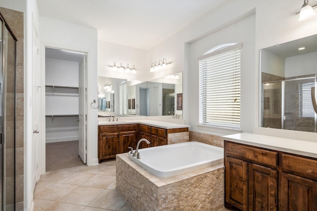 546 El Camino Dr, Frisco, TX 75036 - full bathroom featuring a shower stall, vanity, a bath, a spacious closet, and tile patterned flooring