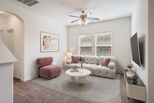 546 El Camino Dr, Frisco, TX 75036 - living area featuring carpet, arched walkways, a ceiling fan, and baseboards