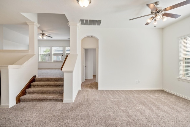 546 El Camino Dr, Frisco, TX 75036 - stairs with carpet, a ceiling fan, decorative columns, arched walkways, and baseboards