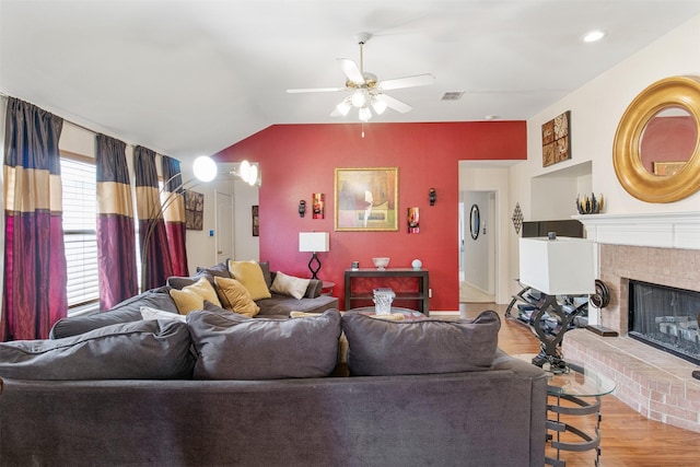 141 Buffalo Creek Dr, Desoto, TX 75115 - living area featuring wood finished floors, a ceiling fan, lofted ceiling, and a brick fireplace