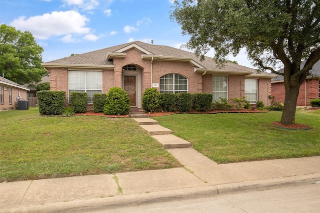 141 Buffalo Creek Dr, Desoto, TX 75115 - view of front of property with cooling unit, a front lawn, brick siding, and roof with shingles