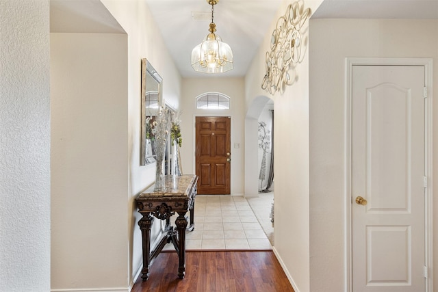 141 Buffalo Creek Dr, Desoto, TX 75115 - foyer entrance with a chandelier, arched walkways, and wood finished floors