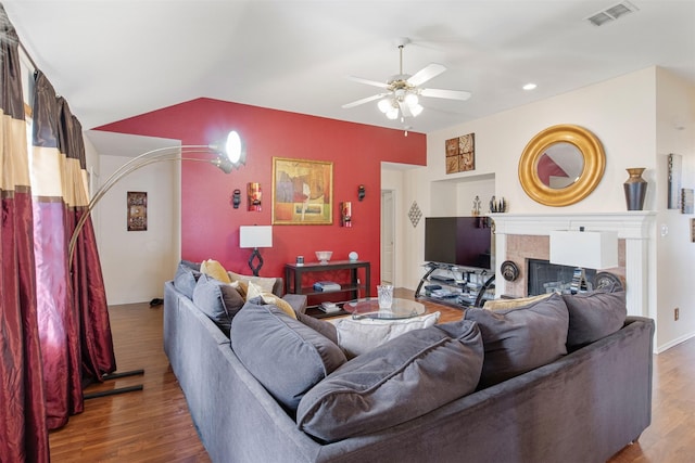 141 Buffalo Creek Dr, Desoto, TX 75115 - living room featuring wood finished floors, a ceiling fan, a tile fireplace, vaulted ceiling, and baseboards