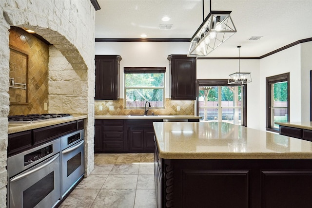 950 Roxbury Way, Keller, TX 76248 - kitchen featuring stainless steel appliances, a sink, tasteful backsplash, ornamental molding, and a chandelier