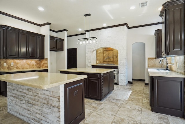950 Roxbury Way, Keller, TX 76248 - kitchen featuring a kitchen island, crown molding, tasteful backsplash, a sink, and dark brown cabinets