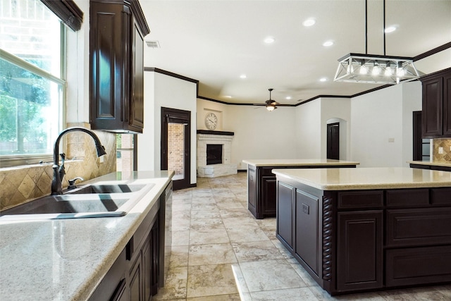 950 Roxbury Way, Keller, TX 76248 - kitchen featuring a sink, ceiling fan, decorative backsplash, dark brown cabinetry, and a center island