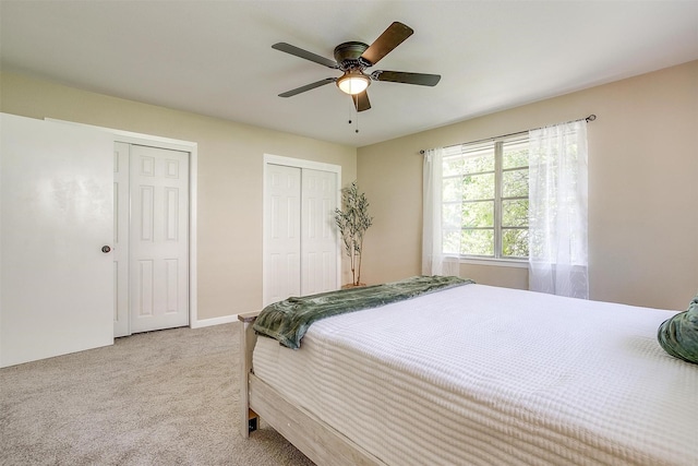 1309 Manor Dr, Cleburne, TX 76033 - bedroom featuring two closets, carpet floors, ceiling fan, and baseboards