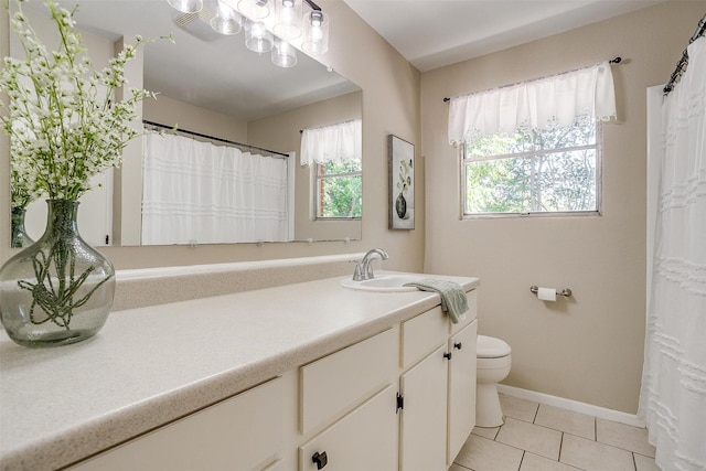 1309 Manor Dr, Cleburne, TX 76033 - full bath with toilet, vanity, tile patterned floors, baseboards, and curtained shower