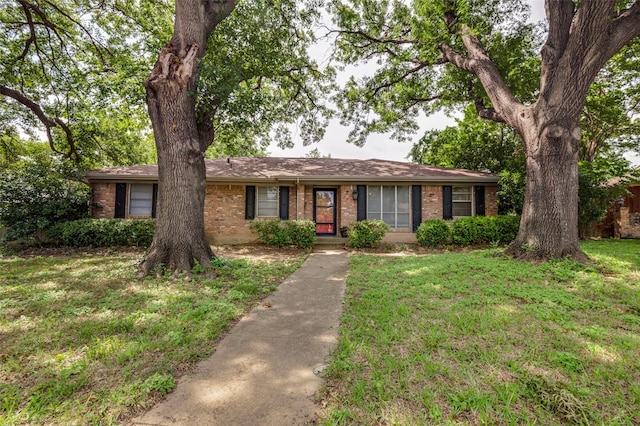 1409 Roman Rd, Grand Prairie, TX 75050 - single story home featuring brick siding and a front lawn