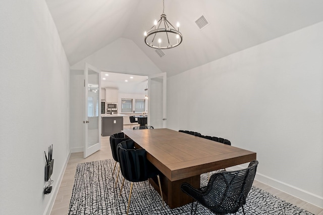 2316 Lazy Dog Ln, Northlake, TX 76247 - dining space with a chandelier, vaulted ceiling, light wood-style flooring, and baseboards