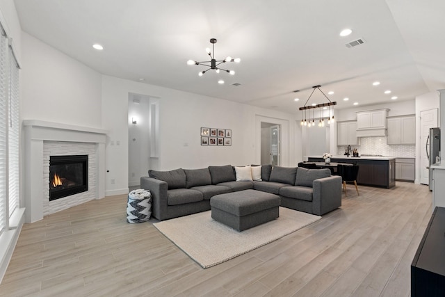 2316 Lazy Dog Ln, Northlake, TX 76247 - living room featuring a chandelier, light wood-type flooring, recessed lighting, a fireplace, and baseboards