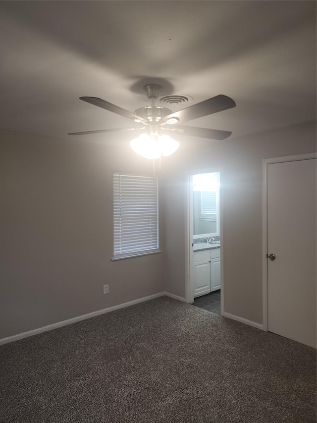 5209 Wharton Dr, Fort Worth, TX 76133 - empty room featuring ceiling fan, dark carpet, baseboards, and a sink