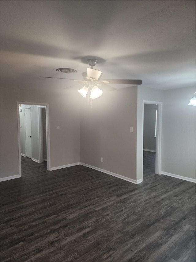 5209 Wharton Dr, Fort Worth, TX 76133 - spare room with baseboards, ceiling fan, and dark wood-type flooring