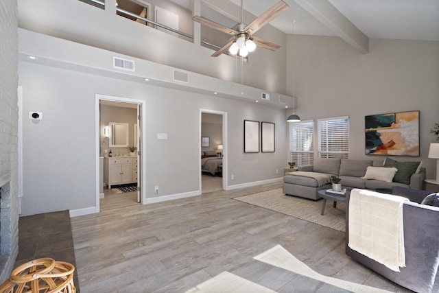 2645 Forest Grove Dr, Richardson, TX 75080 - living room with a ceiling fan, beam ceiling, light wood-style flooring, a high ceiling, and baseboards