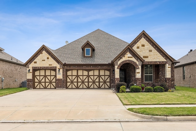 1685 Laramie Ln, Burleson, TX 76028 - view of front facade with brick siding, a front lawn, central air condition unit, roof with shingles, and driveway