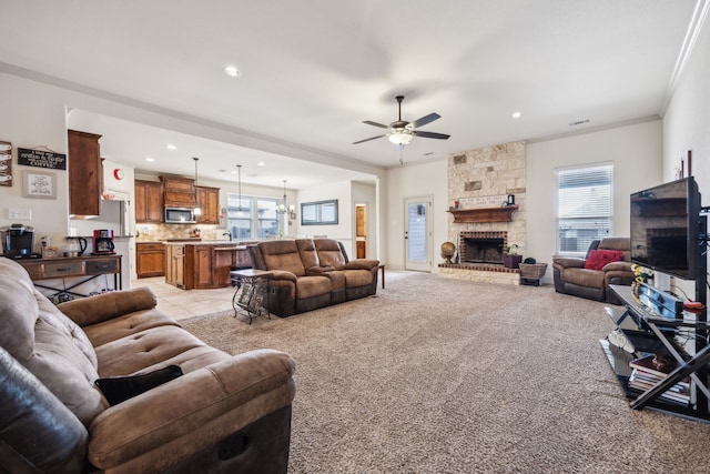 1685 Laramie Ln, Burleson, TX 76028 - living area featuring a ceiling fan, healthy amount of natural light, recessed lighting, a fireplace, and crown molding