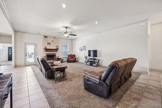 1685 Laramie Ln, Burleson, TX 76028 - living area with light tile patterned floors, ceiling fan, a stone fireplace, crown molding, and recessed lighting