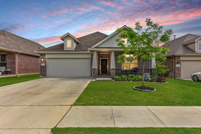 601 Big Horn Pass, Denton, TX 76210 - traditional home with a garage, brick siding, a yard, and driveway