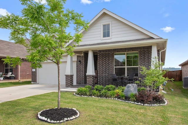 601 Big Horn Pass, Denton, TX 76210 - view of front facade featuring brick siding, driveway, a garage, and central air condition unit
