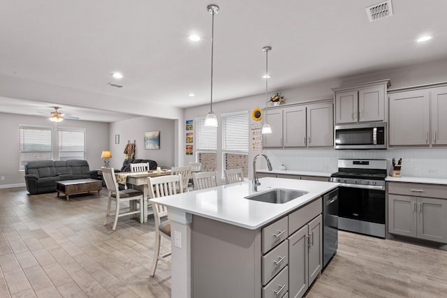 601 Big Horn Pass, Denton, TX 76210 - kitchen featuring stainless steel appliances, gray cabinets, a sink, plenty of natural light, and recessed lighting