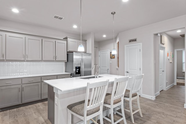 601 Big Horn Pass, Denton, TX 76210 - kitchen featuring gray cabinetry, stainless steel fridge, a sink, light wood-style floors, and light countertops
