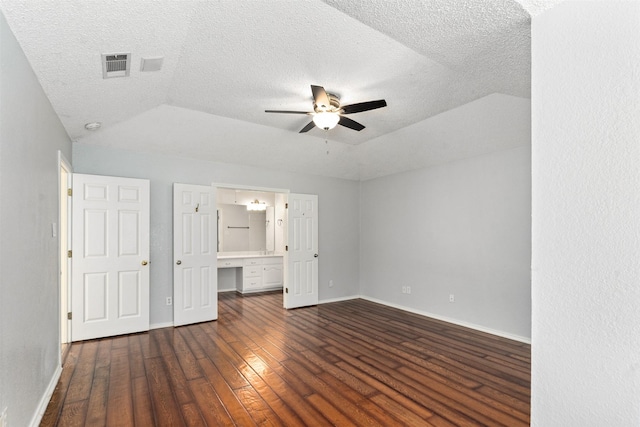 120 Royalwood Dr, Mabank, TX 75156 - unfurnished bedroom featuring dark wood-style flooring, baseboards, a textured ceiling, connected bathroom, and ceiling fan
