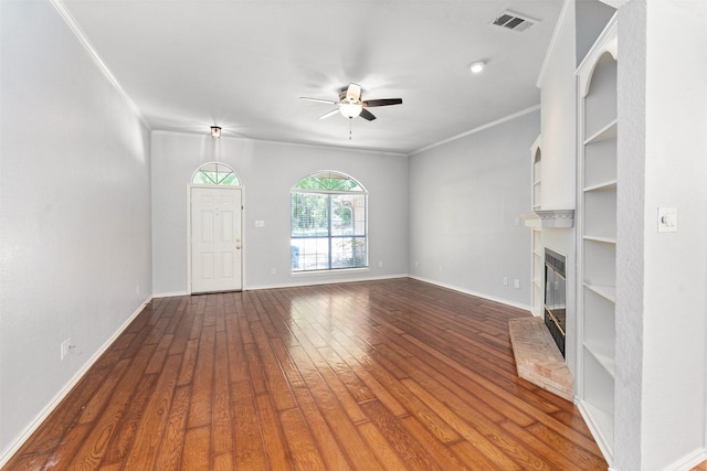 120 Royalwood Dr, Mabank, TX 75156 - unfurnished living room with a ceiling fan, a glass covered fireplace, wood finished floors, baseboards, and ornamental molding