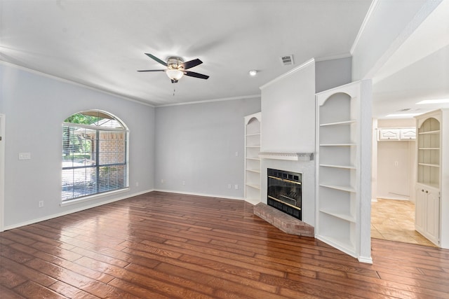 120 Royalwood Dr, Mabank, TX 75156 - unfurnished living room with wood-type flooring, ceiling fan, crown molding, a fireplace, and built in features