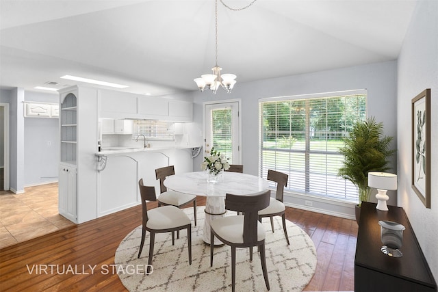 120 Royalwood Dr, Mabank, TX 75156 - dining room featuring light wood-style floors, a chandelier, lofted ceiling, and baseboards