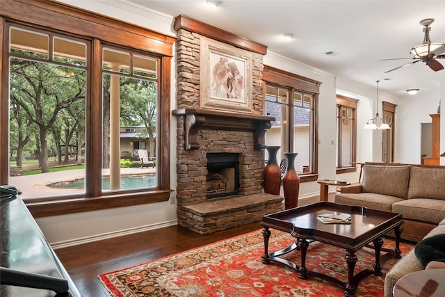 6815 Fm 1830, Argyle, TX 76226 - living area with a ceiling fan, a stone fireplace, hardwood / wood-style floors, and crown molding
