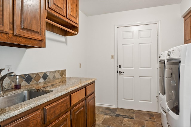 6815 Fm 1830, Argyle, TX 76226 - washroom featuring washing machine and dryer, cabinet space, and dark stone finish flooring