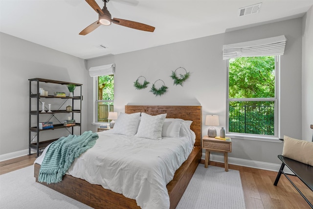 7885 Hickory Branch Dr, Frisco, TX 75034 - bedroom with wood finished floors, baseboards, and a ceiling fan