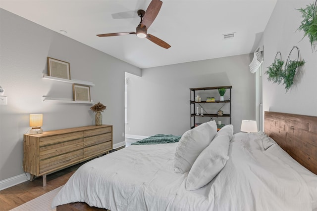 7885 Hickory Branch Dr, Frisco, TX 75034 - bedroom featuring baseboards, wood finished floors, and a ceiling fan
