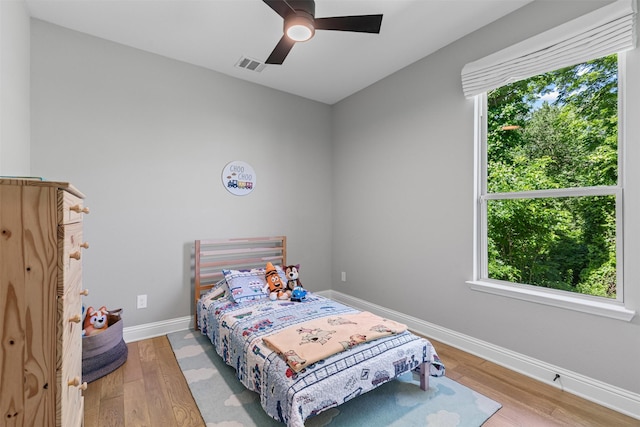 7885 Hickory Branch Dr, Frisco, TX 75034 - bedroom with baseboards, wood finished floors, and ceiling fan