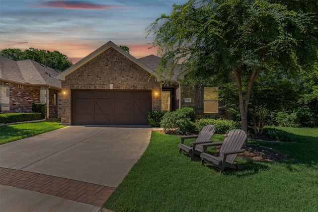 7885 Hickory Branch Dr, Frisco, TX 75034 - view of front of house with an attached garage, brick siding, concrete driveway, and a yard