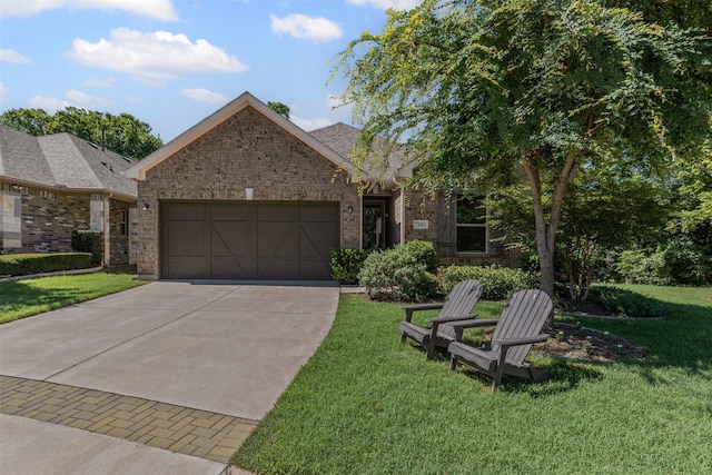 7885 Hickory Branch Dr, Frisco, TX 75034 - view of front of house with a garage, driveway, brick siding, and a front lawn