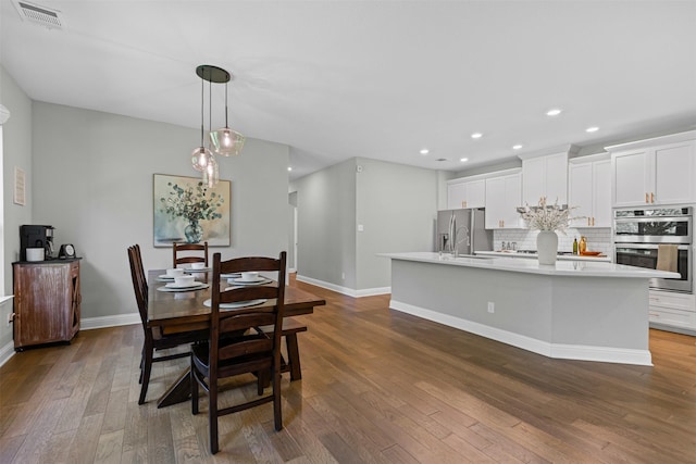 7885 Hickory Branch Dr, Frisco, TX 75034 - dining area featuring dark wood-style flooring, baseboards, and recessed lighting