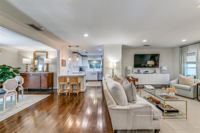 5022 W Hanover Ave, Dallas, TX 75209 - living area with crown molding, dark wood finished floors, and recessed lighting