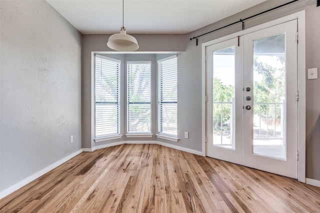 630 W Canty St Unit B6, Dallas, TX 75208 - unfurnished dining area featuring light wood-style floors, healthy amount of natural light, and baseboards