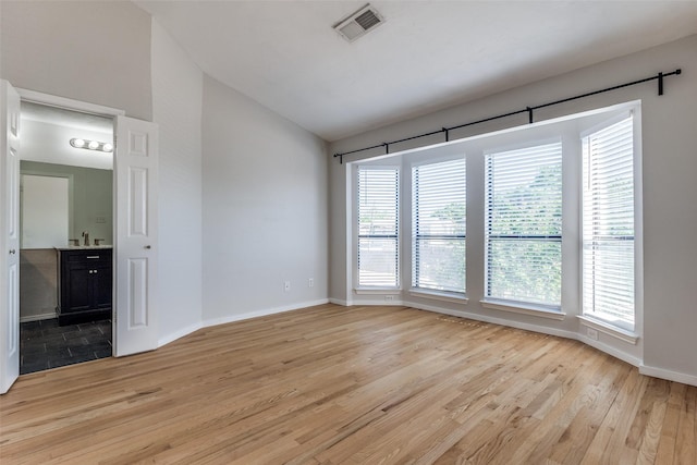 630 W Canty St Unit B6, Dallas, TX 75208 - unfurnished room featuring healthy amount of natural light, light wood finished floors, baseboards, and lofted ceiling