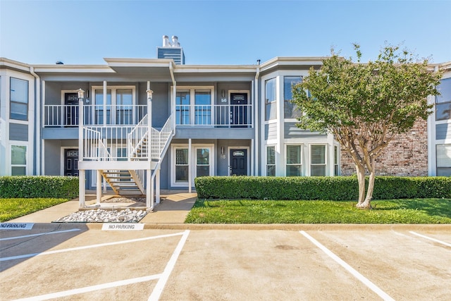 630 W Canty St Unit B6, Dallas, TX 75208 - view of building exterior featuring stairs and uncovered parking