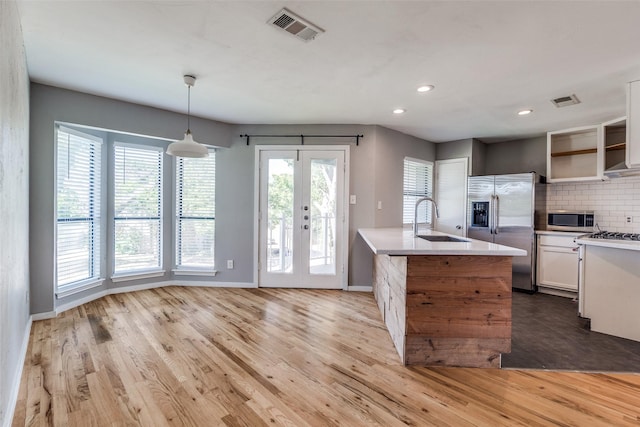 630 W Canty St Unit B6, Dallas, TX 75208 - kitchen featuring appliances with stainless steel finishes, a sink, light countertops, tasteful backsplash, and baseboards