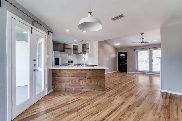 630 W Canty St Unit B6, Dallas, TX 75208 - kitchen featuring appliances with stainless steel finishes, open shelves, light countertops, a sink, and decorative backsplash