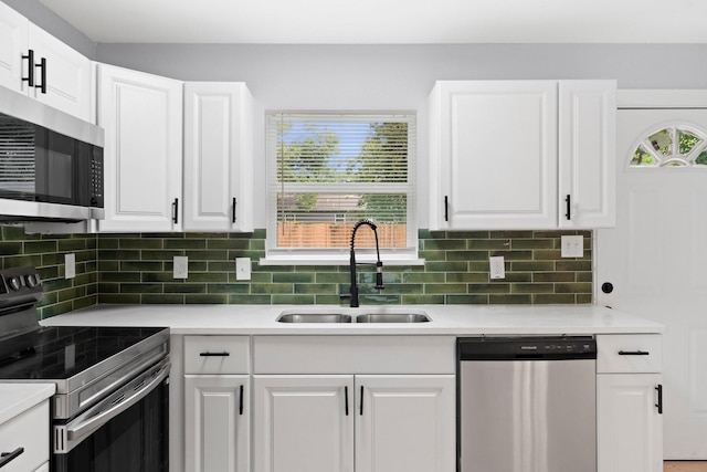 3812 Burton Ave, Fort Worth, TX 76105 - kitchen with stainless steel appliances, a sink, light countertops, and white cabinetry