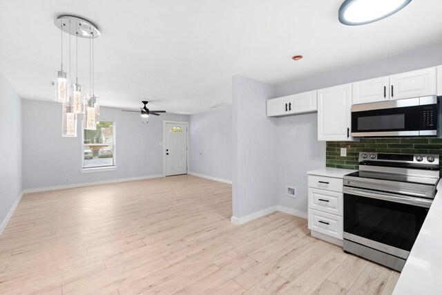 3812 Burton Ave, Fort Worth, TX 76105 - kitchen featuring stainless steel appliances, white cabinetry, light wood-type flooring, light countertops, and pendant lighting