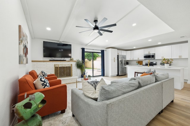 1833 Chamberlain Dr, Carrollton, TX 75007 - living room with a ceiling fan, recessed lighting, a brick fireplace, and light wood-type flooring