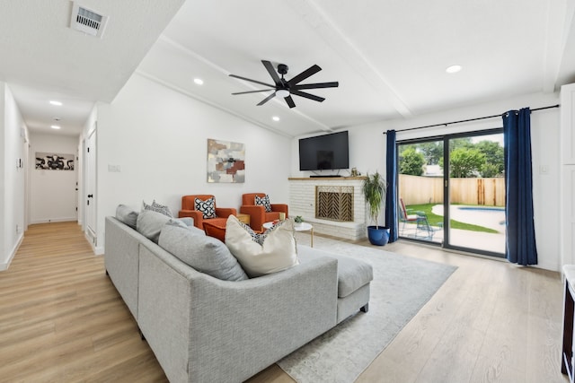 1833 Chamberlain Dr, Carrollton, TX 75007 - living room featuring light wood-style floors, a ceiling fan, recessed lighting, and a fireplace