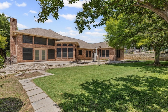 4223 Mojave Dr, Granbury, TX 76049 - back of property featuring a chimney, a patio, and brick siding
